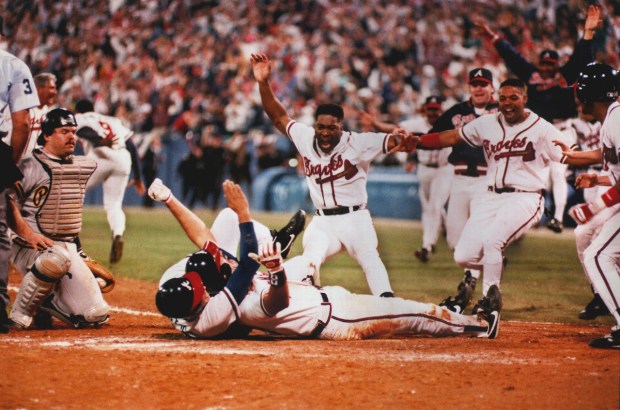 921014 Atlanta - Sid Bream , prone on the ground, gets mobbed by teammates after scoring the winning run in the bottom of the 9th inning of Game 7 of the 1992 NLCS vs the Pittsburg Pirates, giving the Braves the NL Championship. The lumbering Bream scored from 2nd on a Cabrera single to end the game. (AJC Staff/FRANK NIEMEIR)